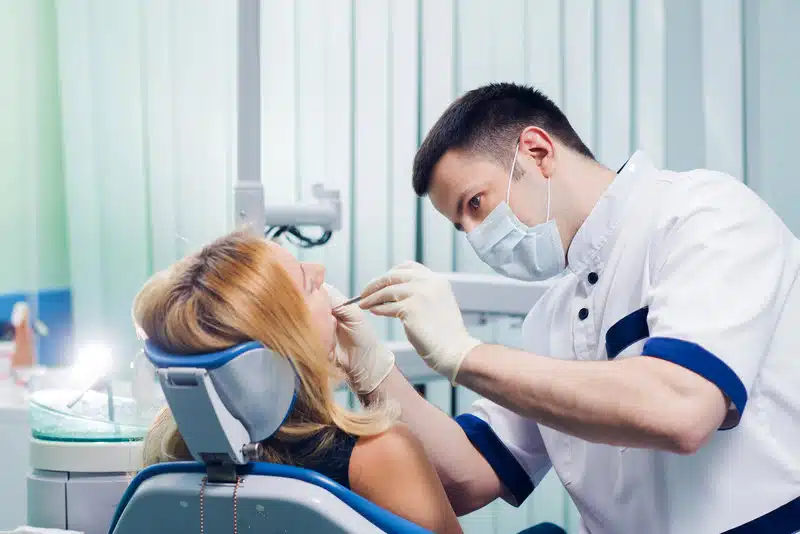 Orthodontist In Ballantyne, Nc 1 Ballantyne Orthodontist Examining A Patient’s Teeth In A Dental Office